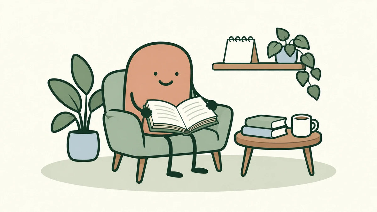 Terracotta character holds an open book with a clear central gutter and interior pages while seated in a green armchair.