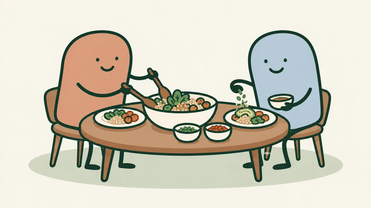 Terracotta and blue characters share a meal from one serving bowl, with separate small bowls of additions.